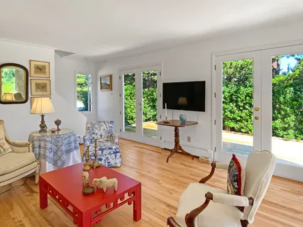 a living room with furniture a large window and a flat screen tv