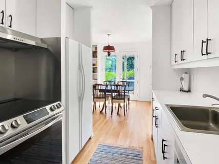 a kitchen with a stove a sink and a refrigerator