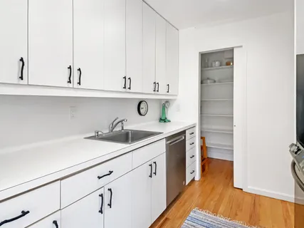 a kitchen with stainless steel appliances a sink and cabinets
