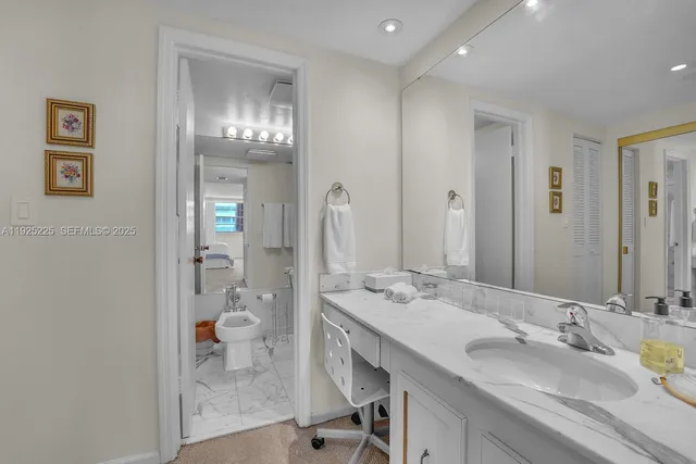 a spacious bathroom with a granite countertop sink a mirror and shower