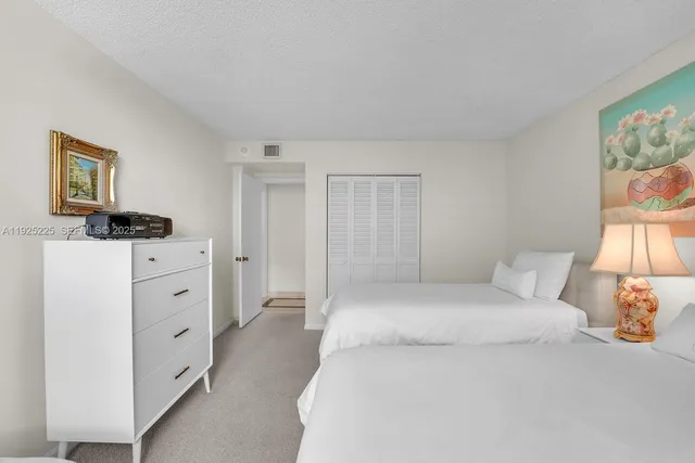 a large white bed in a white room