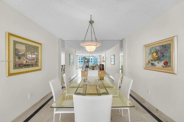 a view of a dining room with furniture wooden floor and a chandelier