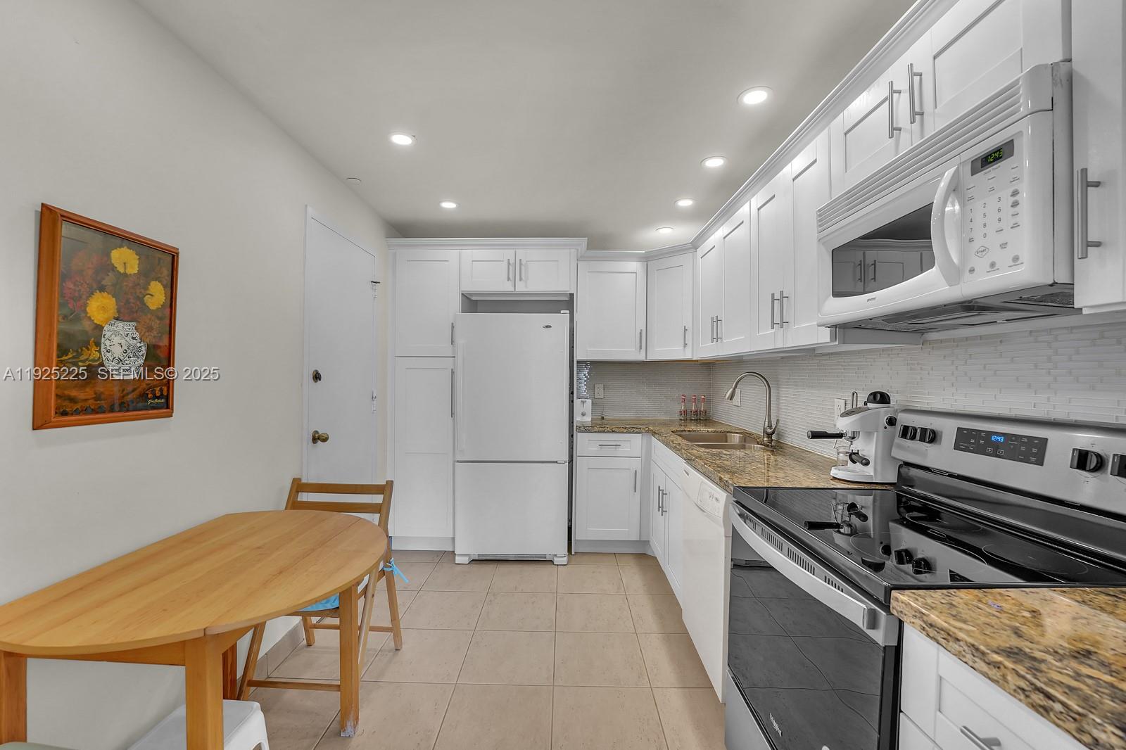 Key Biscayne Key Biscayne, FL 33149 - Photo 8 of 21 a kitchen with stainless steel appliances granite countertop a stove a refrigerator and a microwave