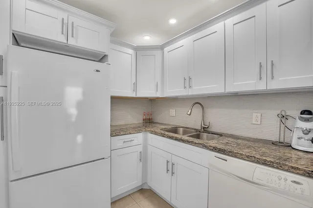a kitchen with appliances cabinets and a counter top space