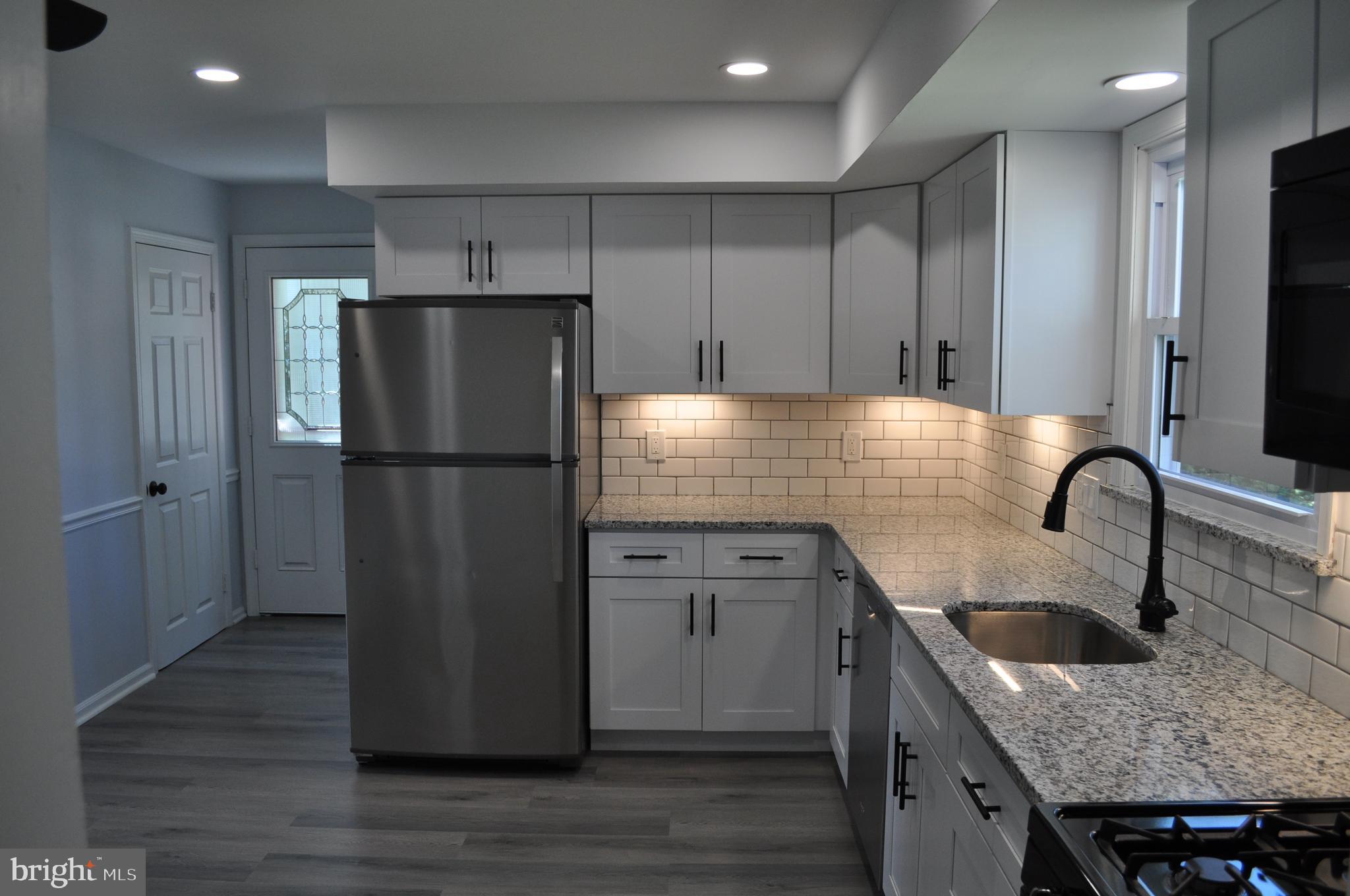 158 South Highland Road Springfield, PA 19064 - Photo 13 of 46 a kitchen with granite countertop a refrigerator and a sink