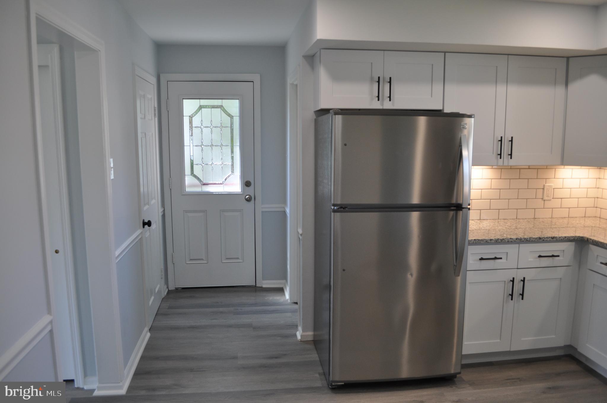 158 South Highland Road Springfield, PA 19064 - Photo 15 of 46 a kitchen with refrigerator and wooden floor