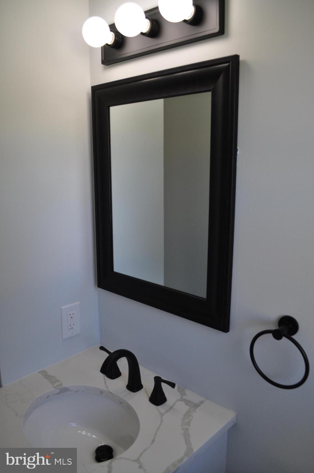 158 South Highland Road Springfield, PA 19064 - Photo 17 of 46 a bathroom with a sink and a mirror