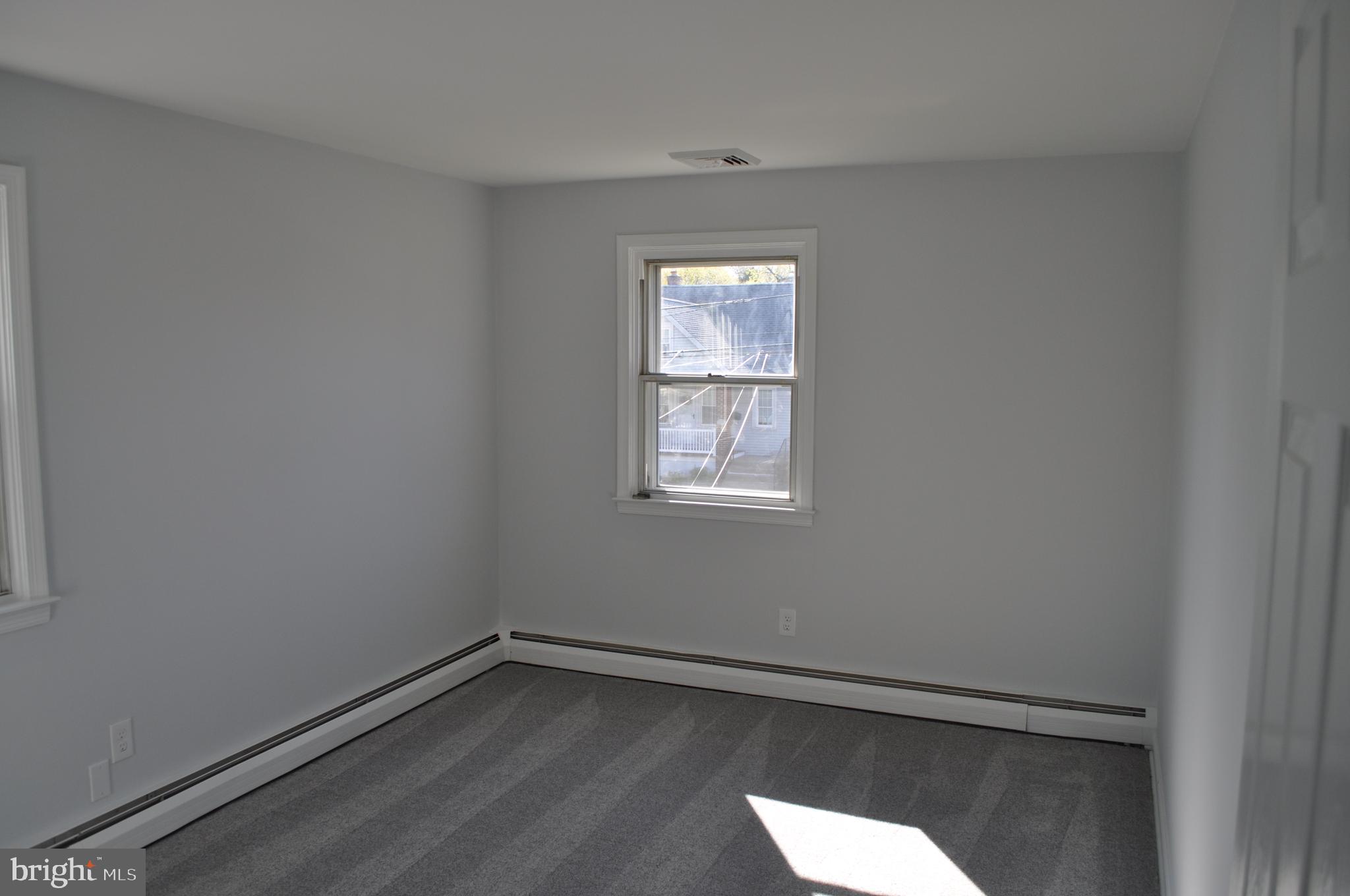 158 South Highland Road Springfield, PA 19064 - Photo 23 of 46 a view of an empty room with wooden floor and a window