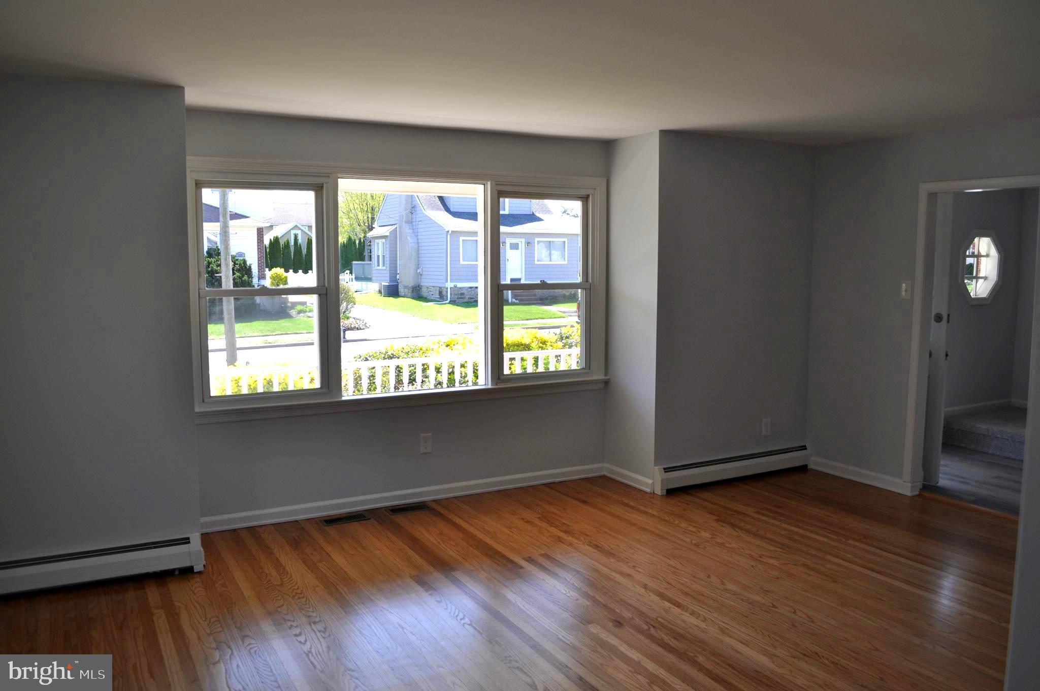 158 South Highland Road Springfield, PA 19064 - Photo 8 of 46 an empty room with wooden floor and windows