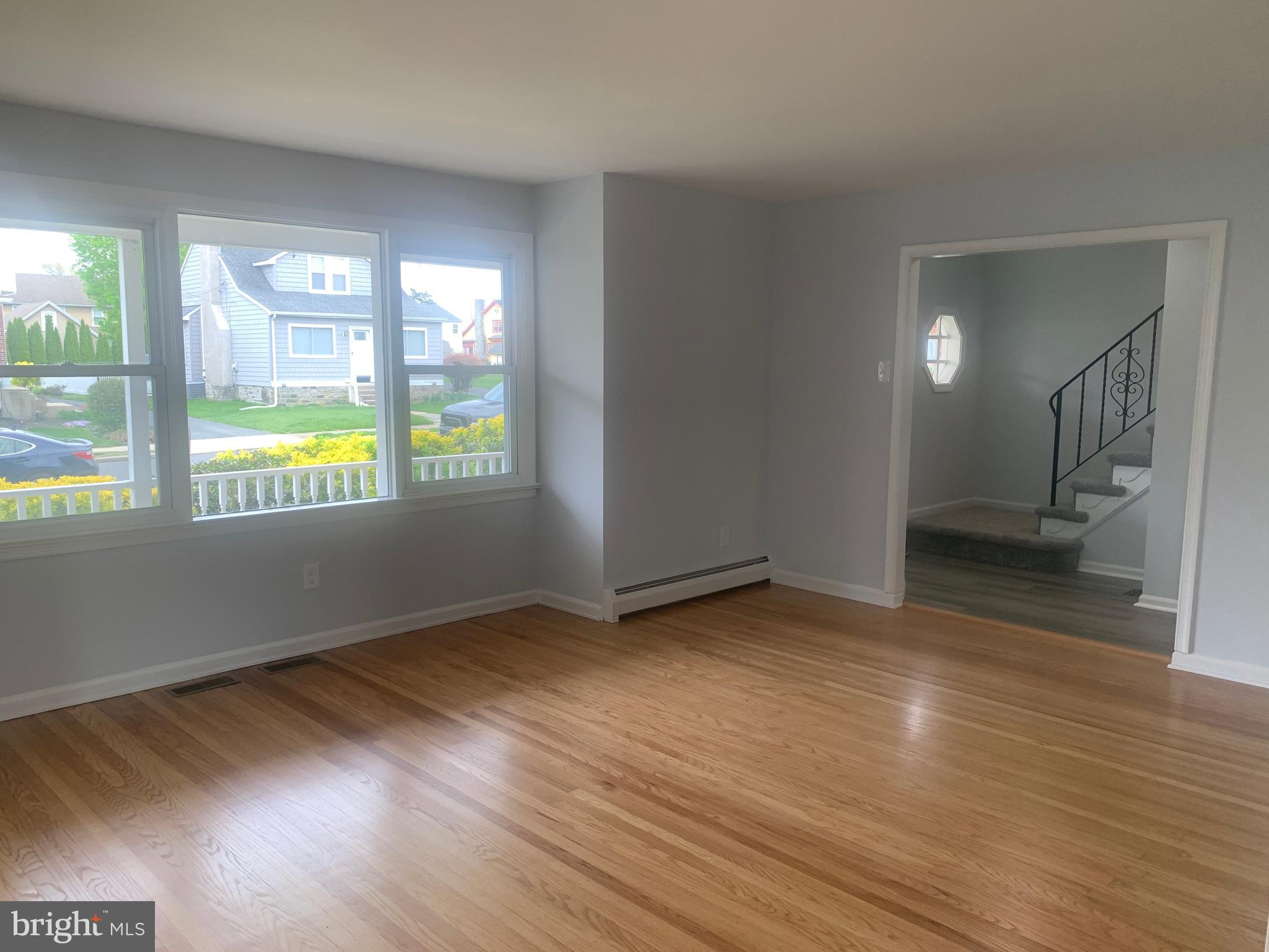 158 South Highland Road Springfield, PA 19064 - Photo 9 of 46 a view of an empty room with wooden floor and a window