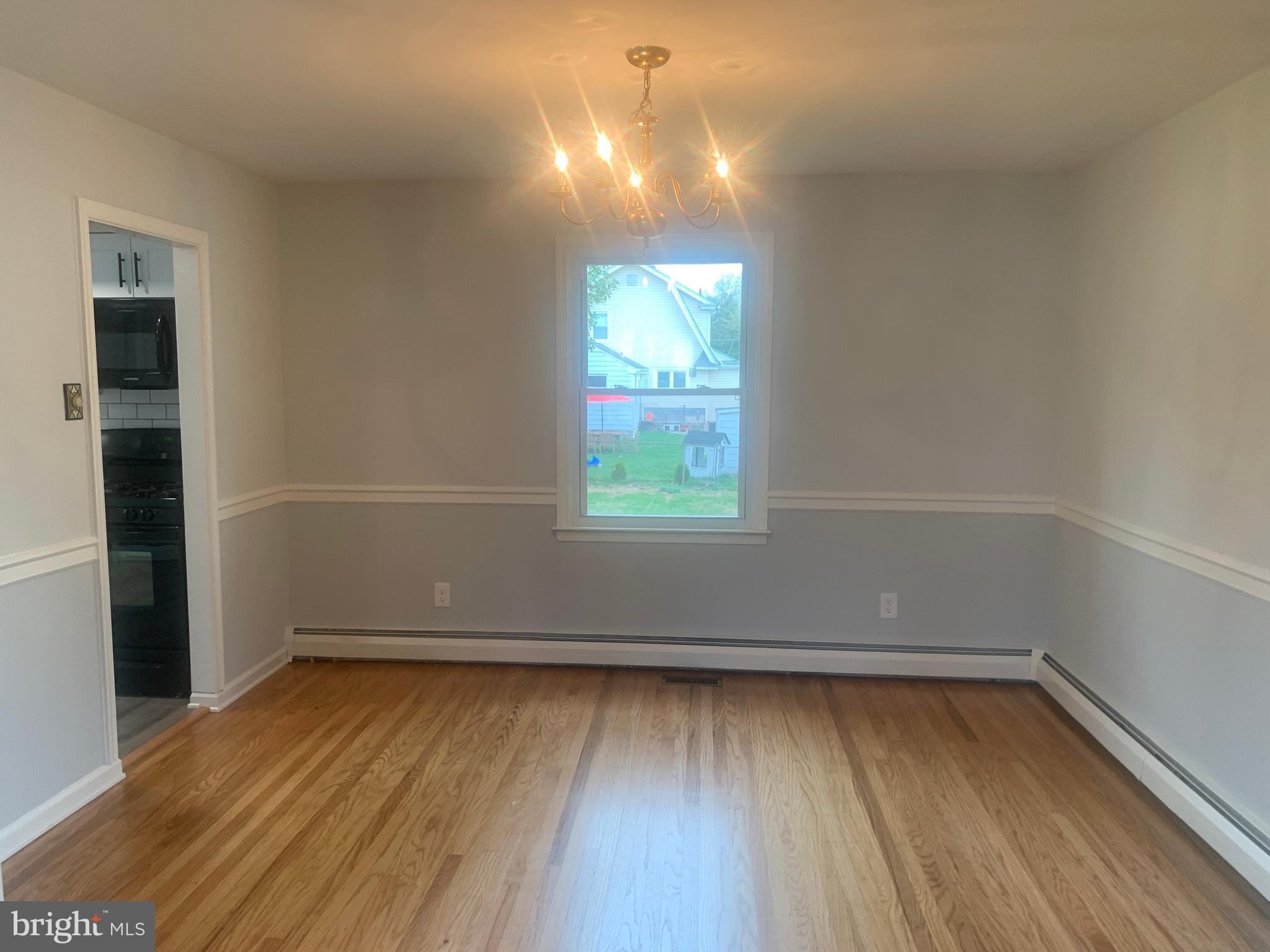 158 South Highland Road Springfield, PA 19064 - Photo 10 of 46 an empty room with wooden floor and windows