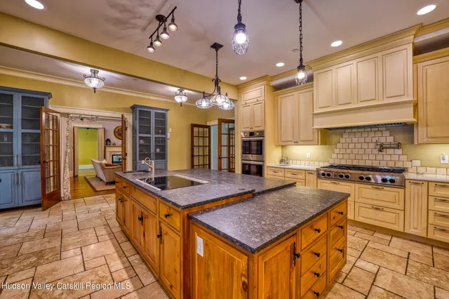 a stove top oven sitting inside of a kitchen