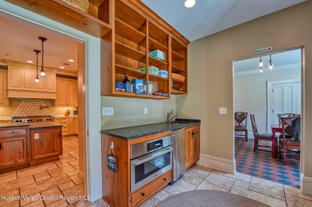 a living room with furniture chandelier and a flat screen tv