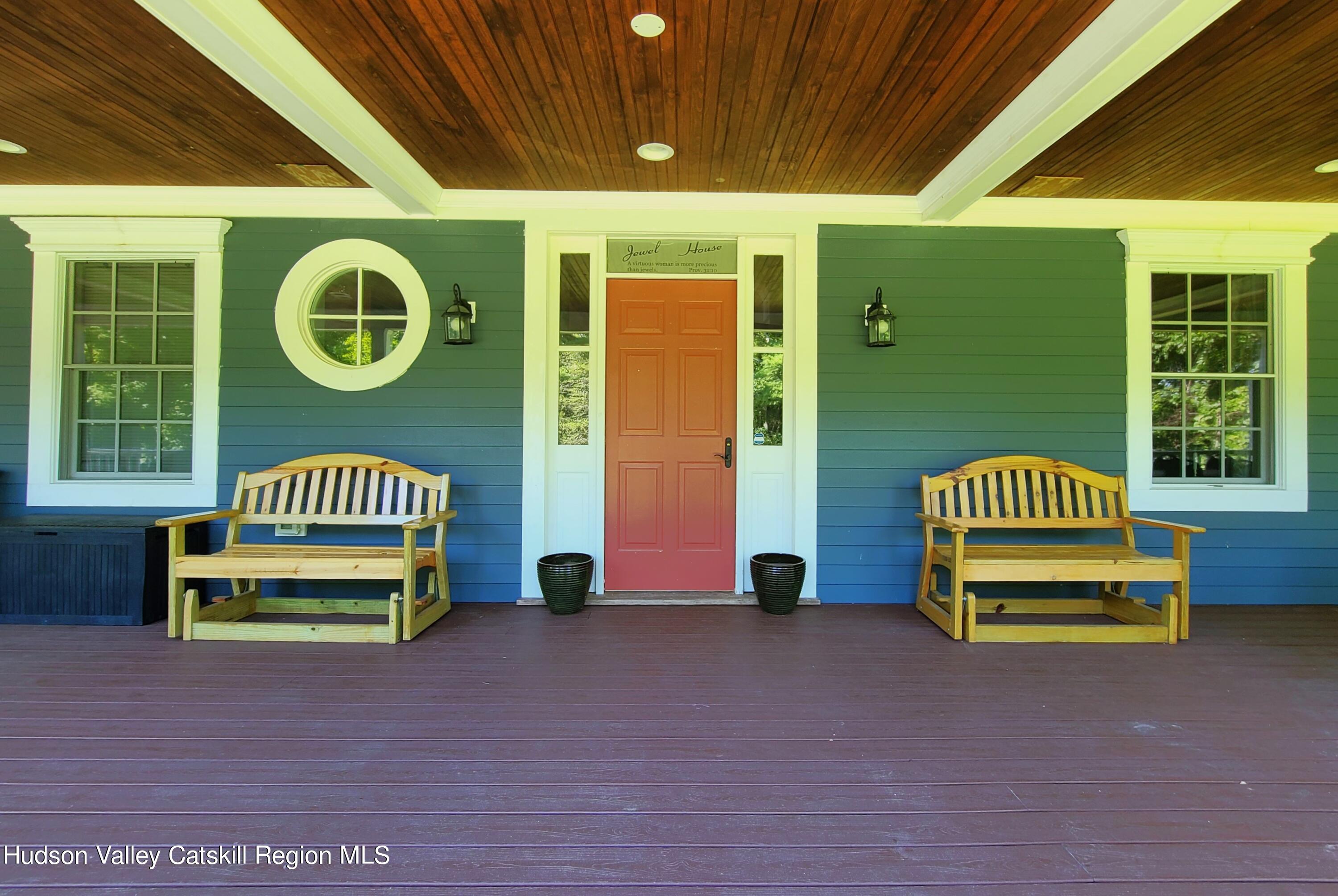 103 Carney Road Ulster Park, NY 12487 - Photo 2 of 89 a front view of a house with a garden and seating space