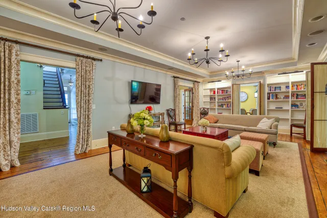 a bedroom with a bed and a table next to a window