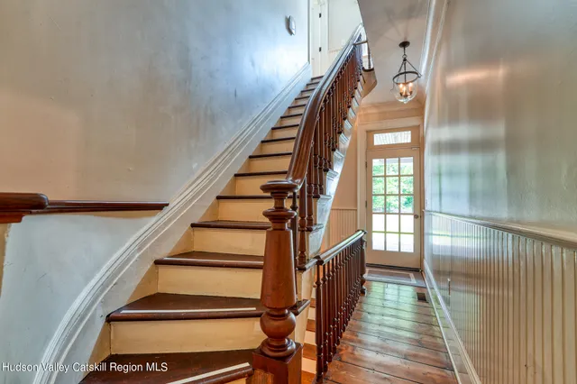 a bedroom with furniture and a large window