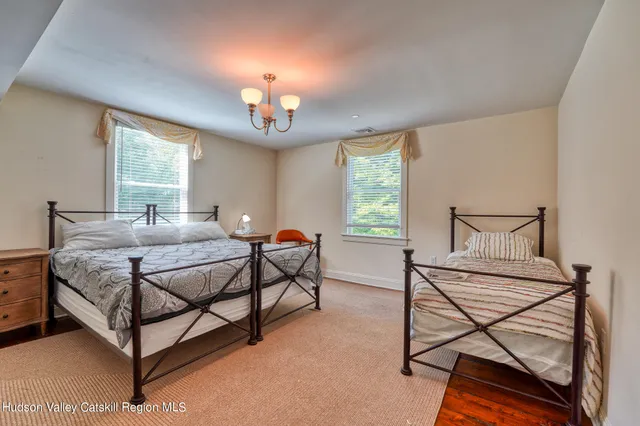 a bedroom with a bed and a mirror