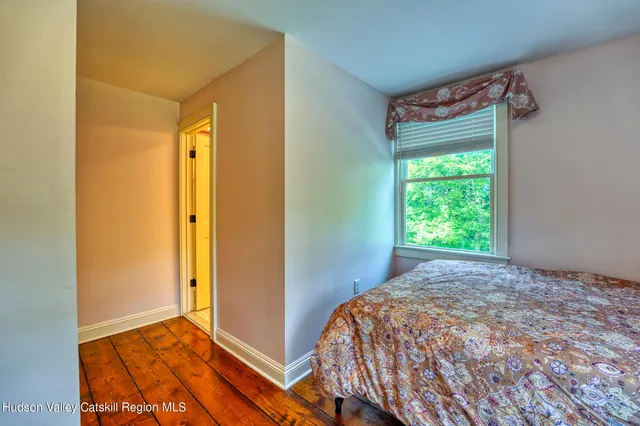 a spacious bedroom with a bed and window