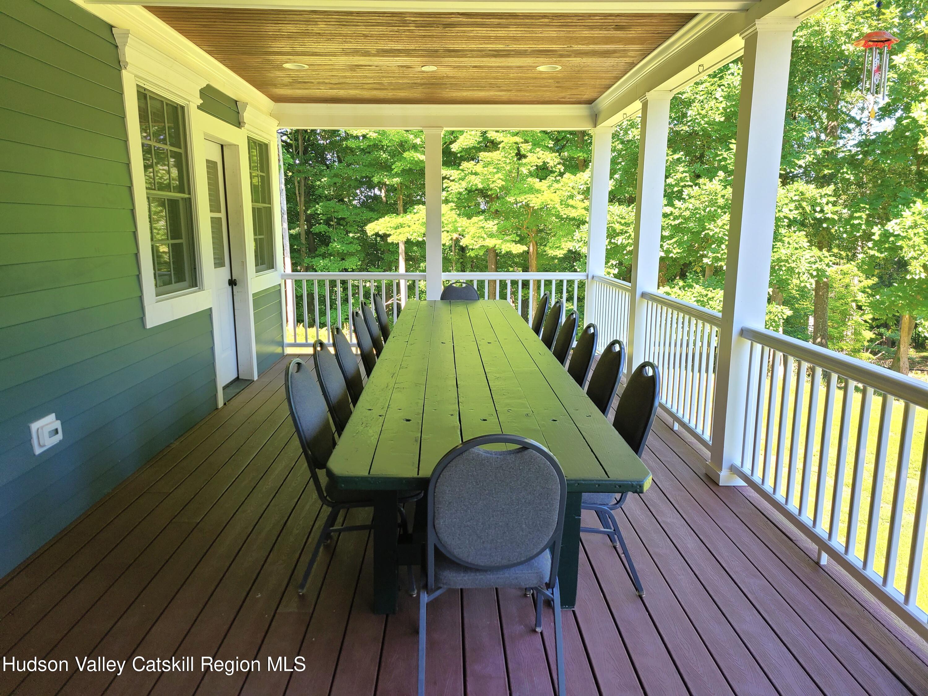 103 Carney Road Ulster Park, NY 12487 - Photo 9 of 89 a view of a wooden deck with a table and chairs