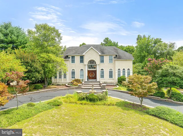 a front view of a house with swimming pool and porch