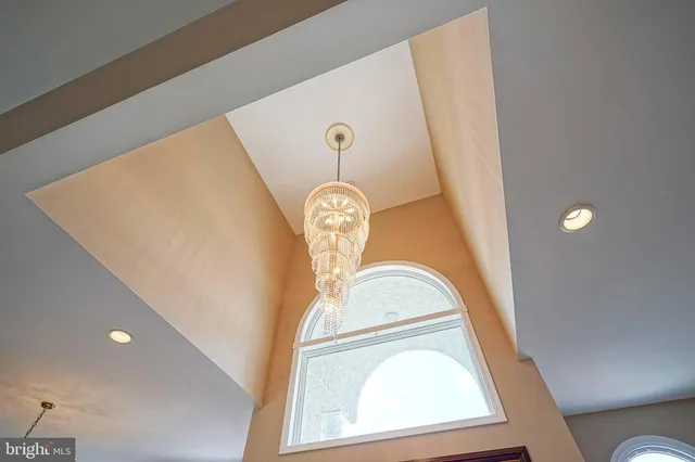 a view of a dining room with furniture and a chandelier