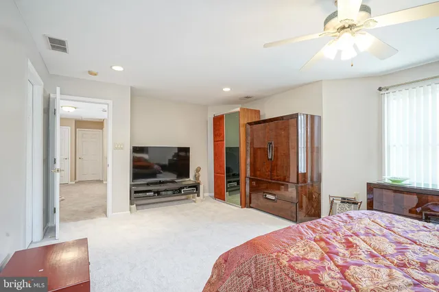 a spacious bathroom with a granite countertop tub sink and mirror