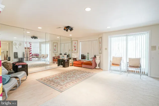 a view of a house with swimming pool and sitting area