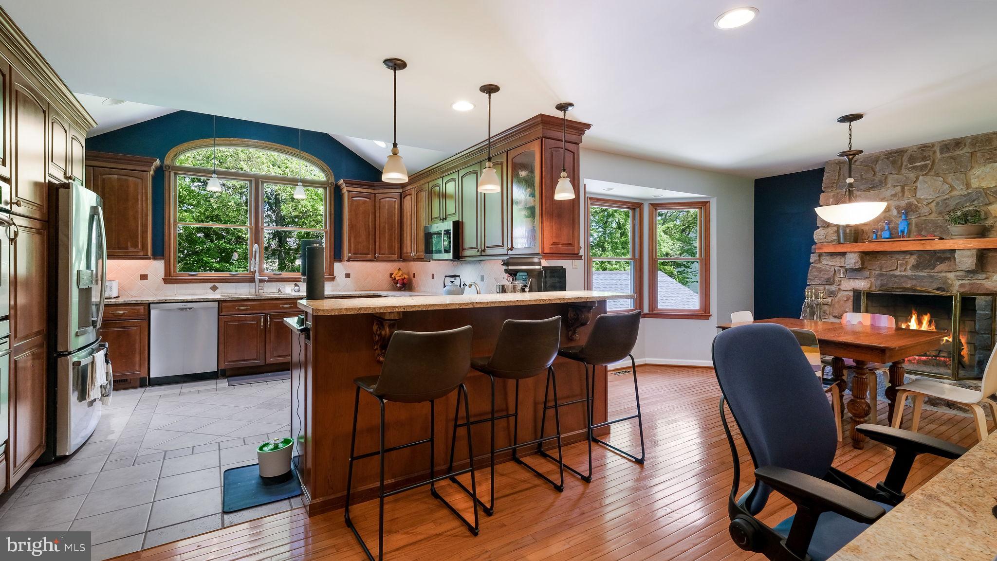 1270 Oxford Valley Road Yardley, PA 19067 - Photo 15 of 39 a dining hall with stainless steel appliances granite countertop a stove a sink dishwasher and white cabinets with wooden floor