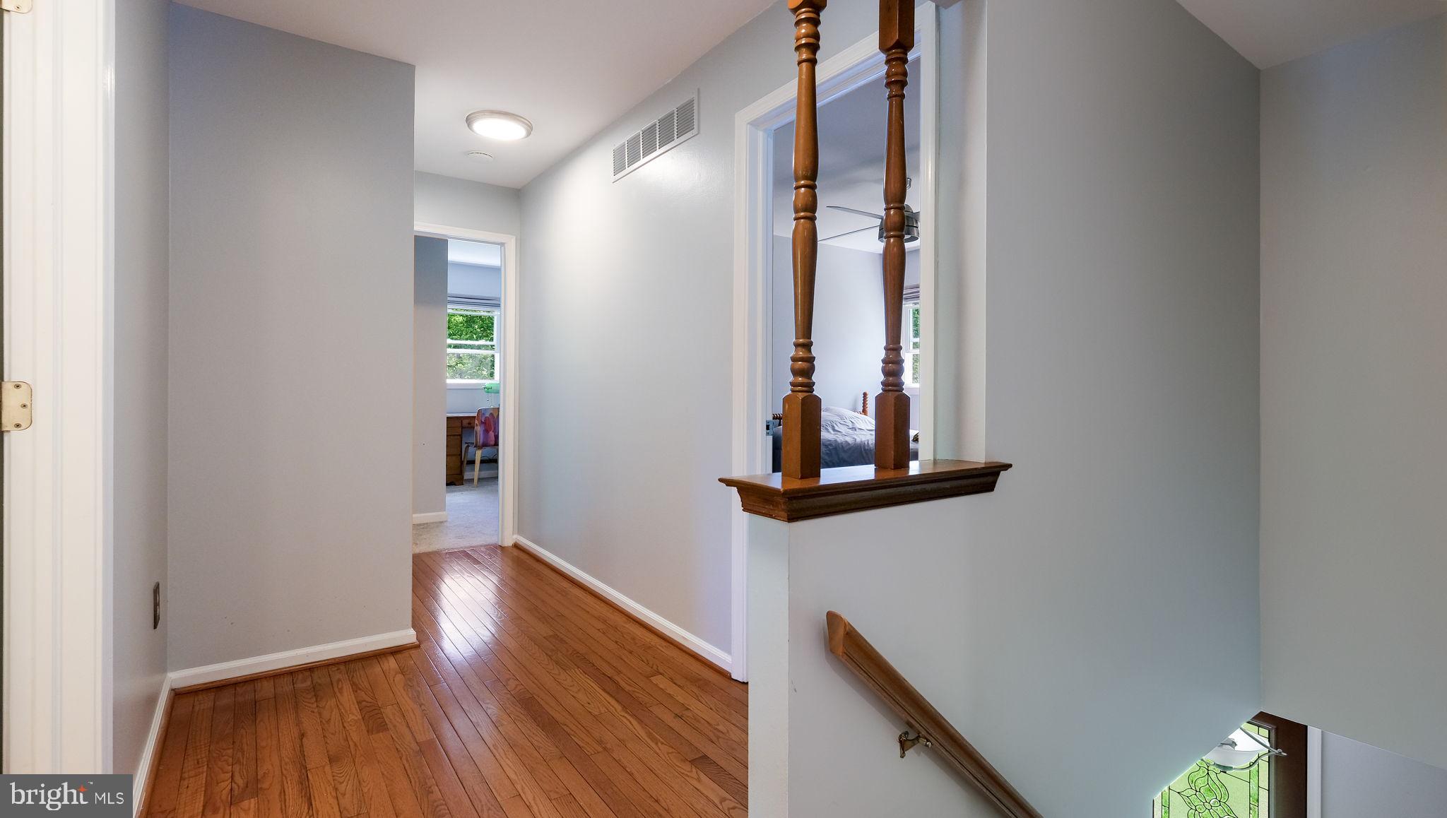 1270 Oxford Valley Road Yardley, PA 19067 - Photo 21 of 39 a view of a hallway with wooden floor and staircase