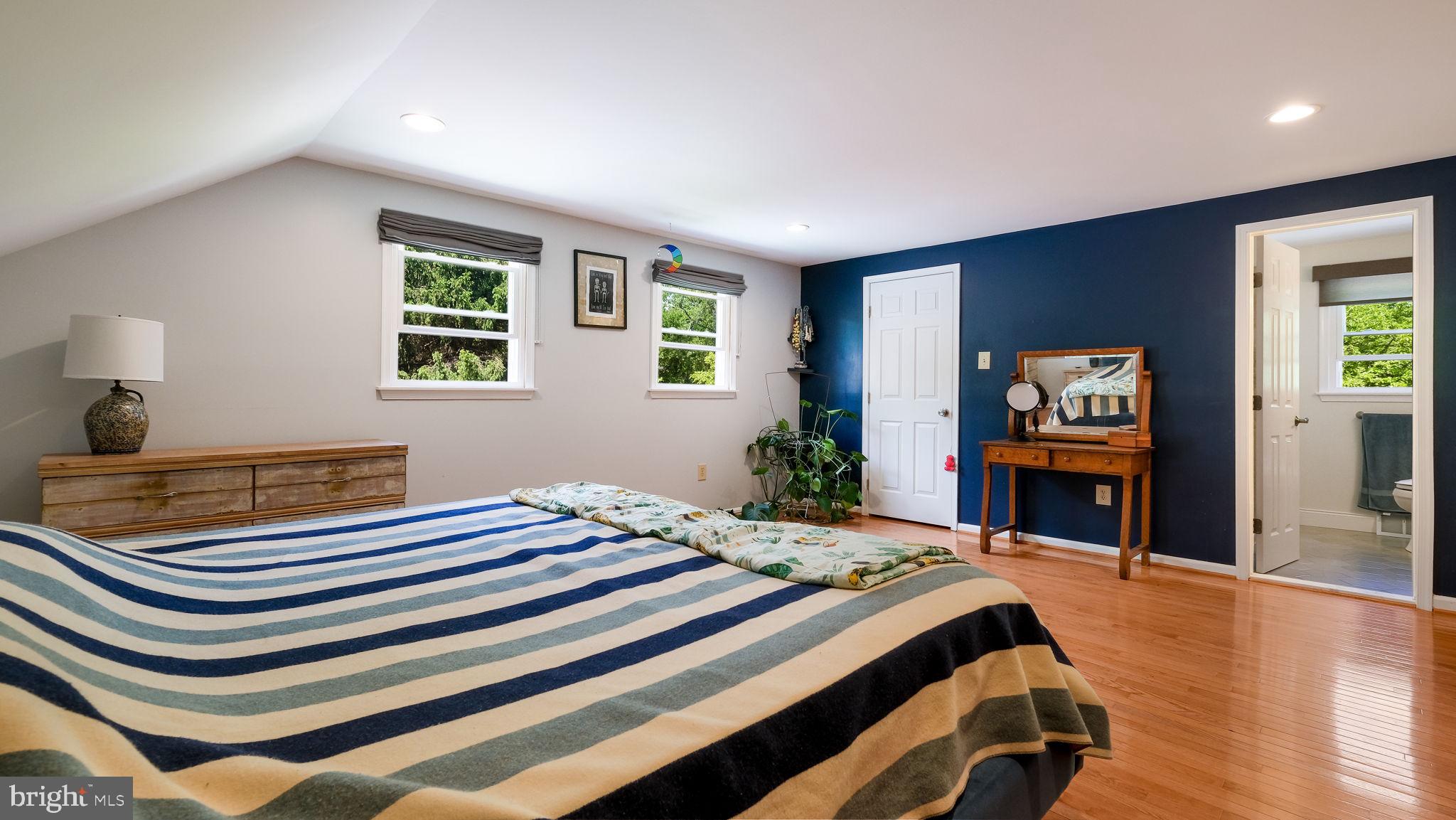 1270 Oxford Valley Road Yardley, PA 19067 - Photo 22 of 39 a bedroom with a bed and a flat screen tv