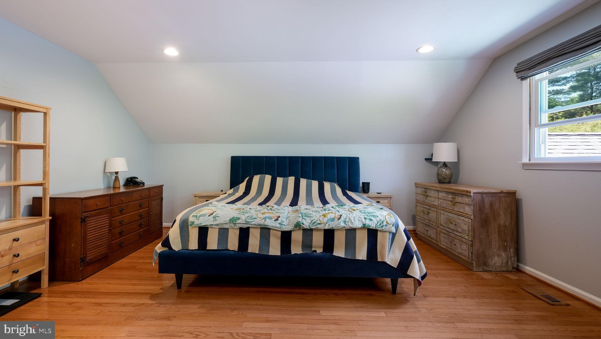 1270 Oxford Valley Road Yardley, PA 19067 - Photo 23 of 39 a bedroom with a bed and wooden floor