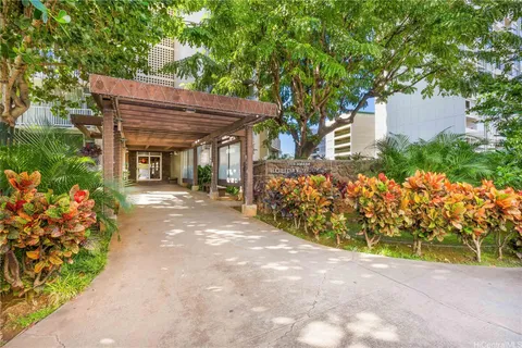 a view of a patio with table and chairs under an umbrella