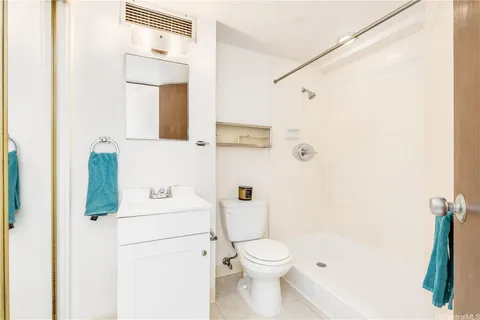 a white toilet sitting next to a bathroom sink