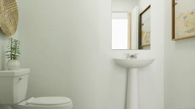 a bathroom with a sink a toilet and mirror