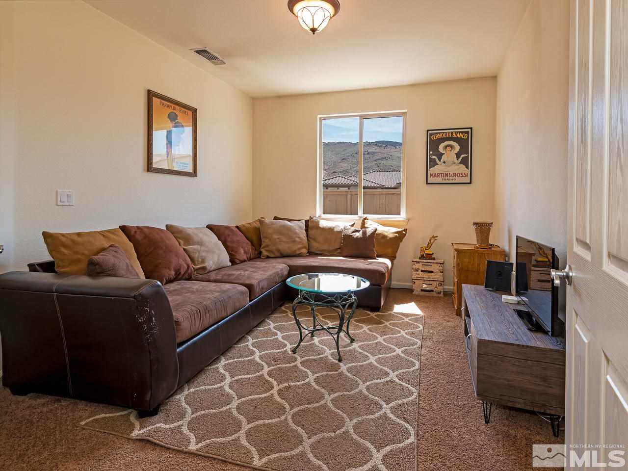 2598 Spring Flower Drive Reno, NV 89521 - Photo 12 of 21 a living room with furniture a rug and a window