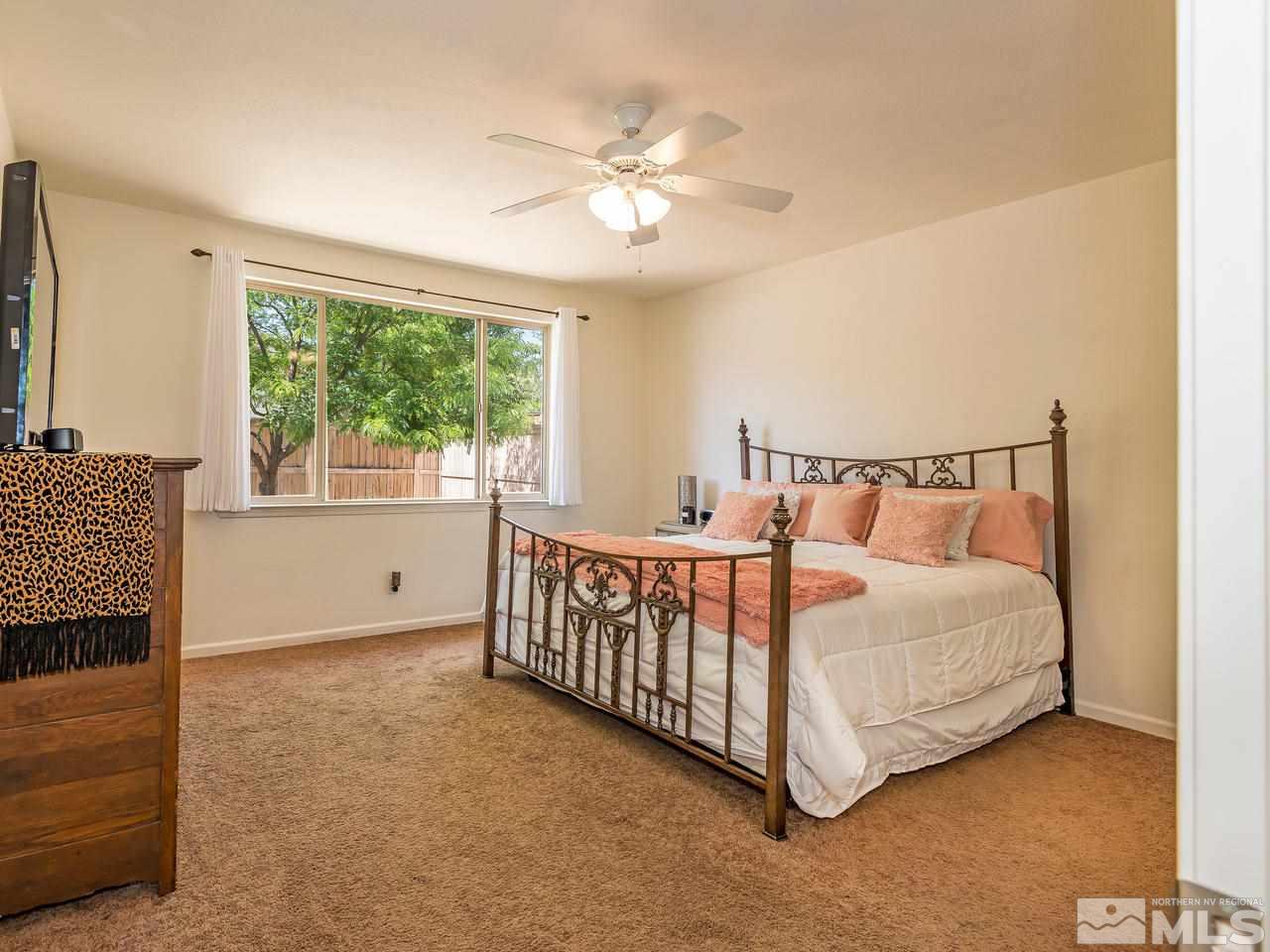 2598 Spring Flower Drive Reno, NV 89521 - Photo 13 of 21 a white bed sitting in a room next to a window