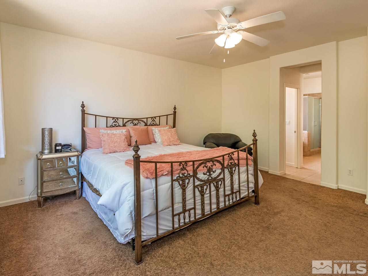 2598 Spring Flower Drive Reno, NV 89521 - Photo 14 of 21 a bedroom with a bed and a ceiling fan