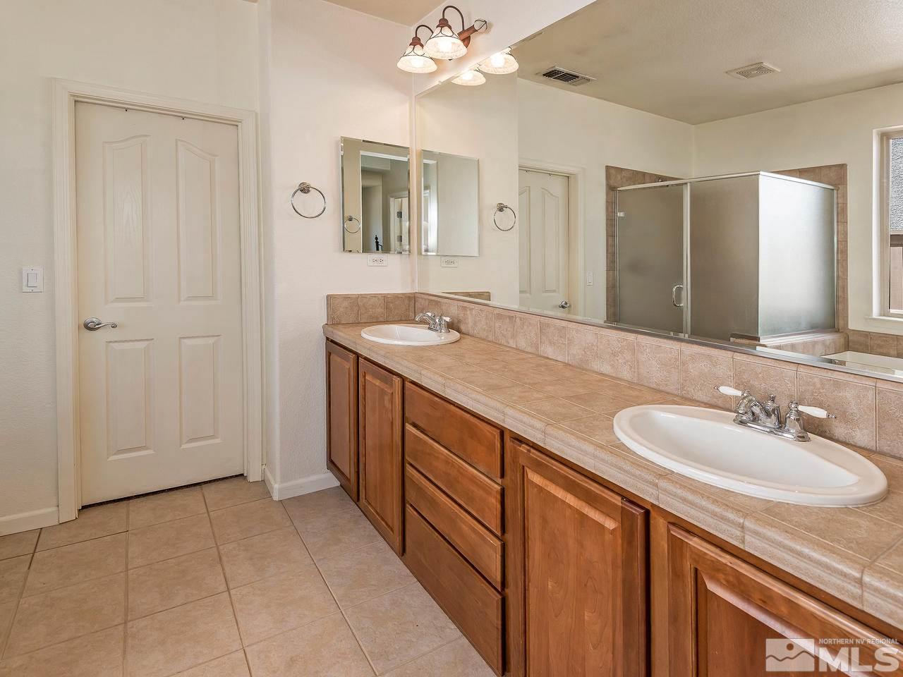 2598 Spring Flower Drive Reno, NV 89521 - Photo 17 of 21 a spacious bathroom with a sink and a mirror