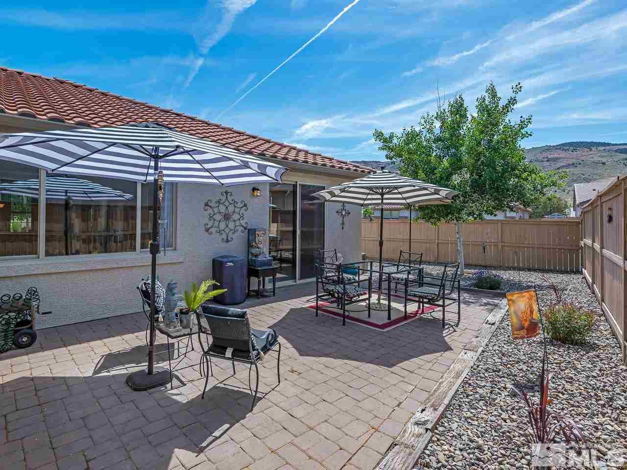 2598 Spring Flower Drive Reno, NV 89521 - Photo 19 of 21 a view of a patio with table and chairs and potted plants
