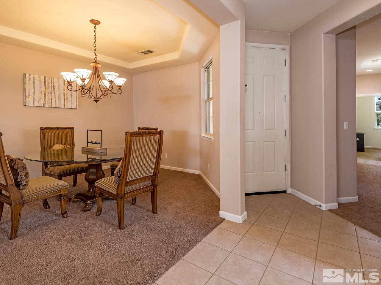 2598 Spring Flower Drive Reno, NV 89521 - Photo 4 of 21 a view of a dining room with furniture and chandelier