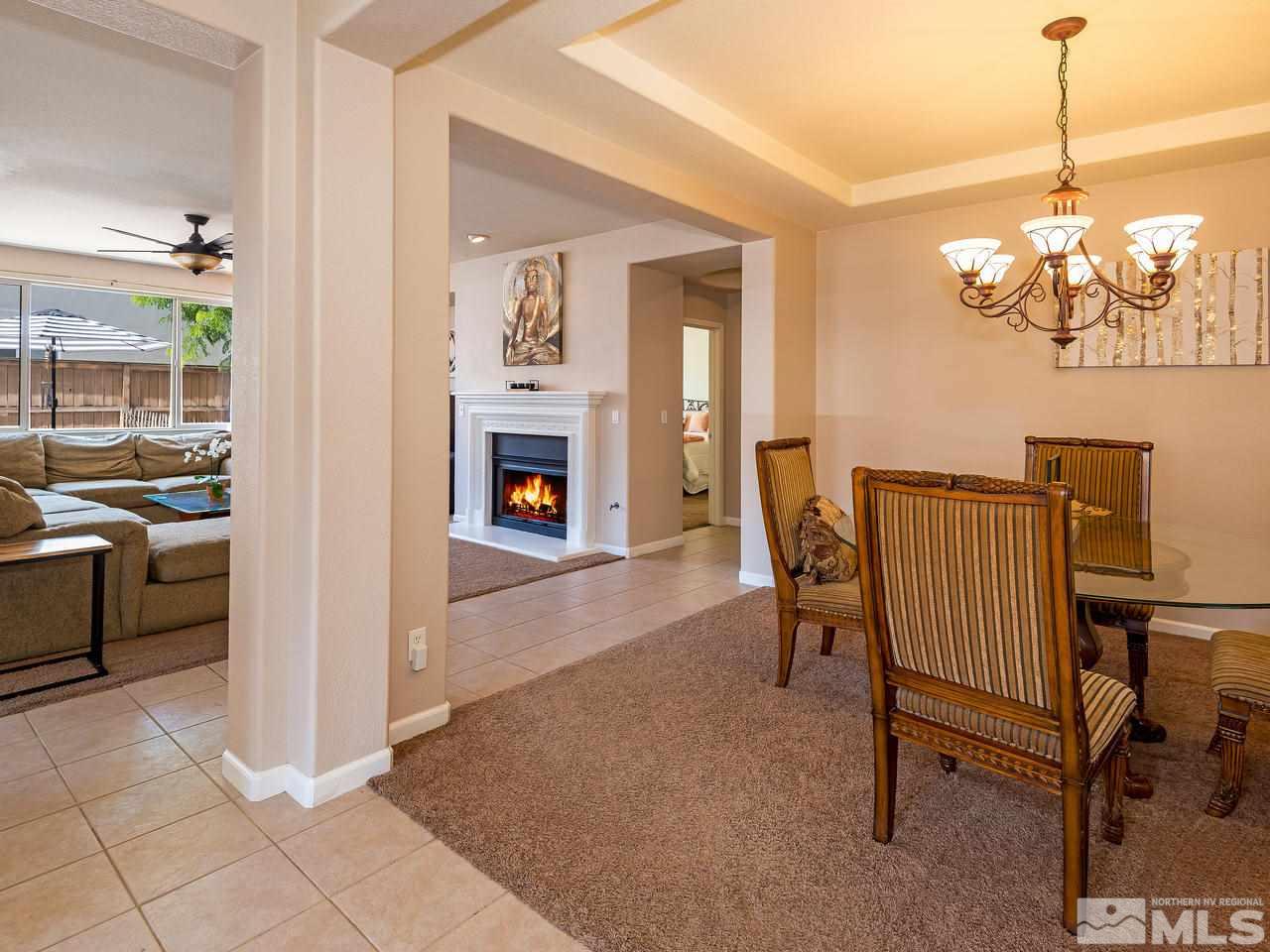 2598 Spring Flower Drive Reno, NV 89521 - Photo 5 of 21 a view of a livingroom with furniture a fireplace and chandelier