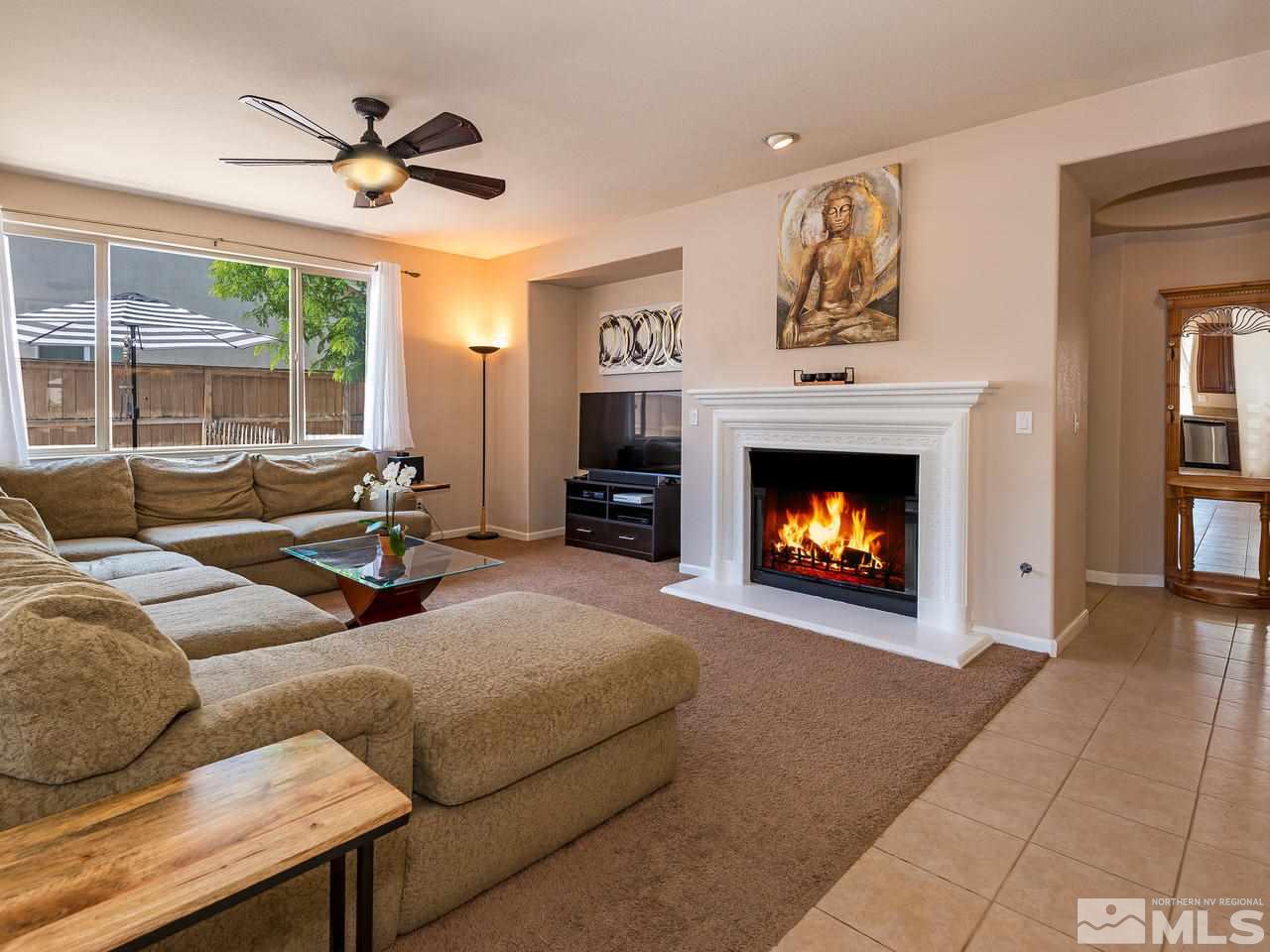 2598 Spring Flower Drive Reno, NV 89521 - Photo 6 of 21 a living room with furniture a fireplace and a large window