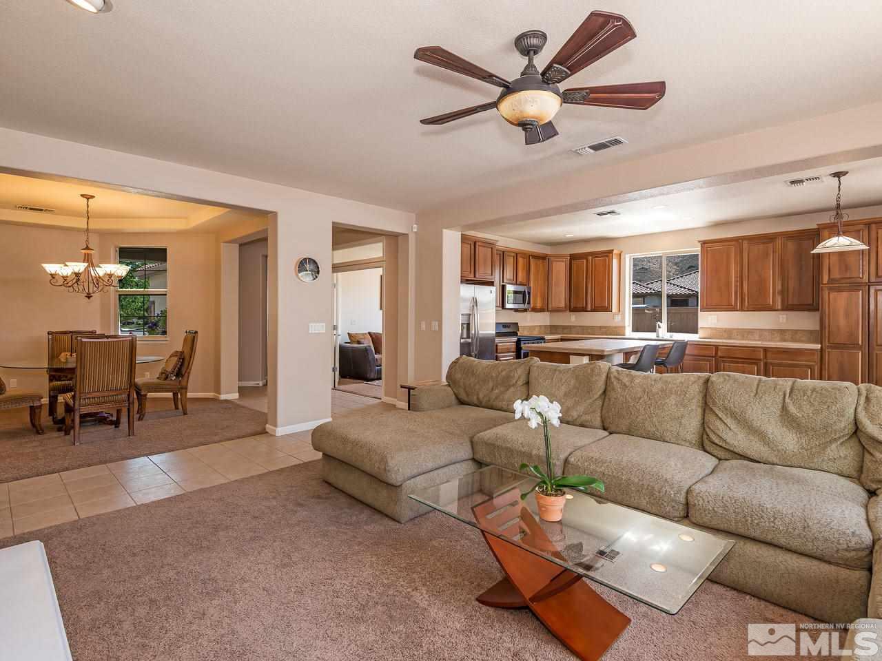 2598 Spring Flower Drive Reno, NV 89521 - Photo 7 of 21 a living room with furniture ceiling fan and a rug