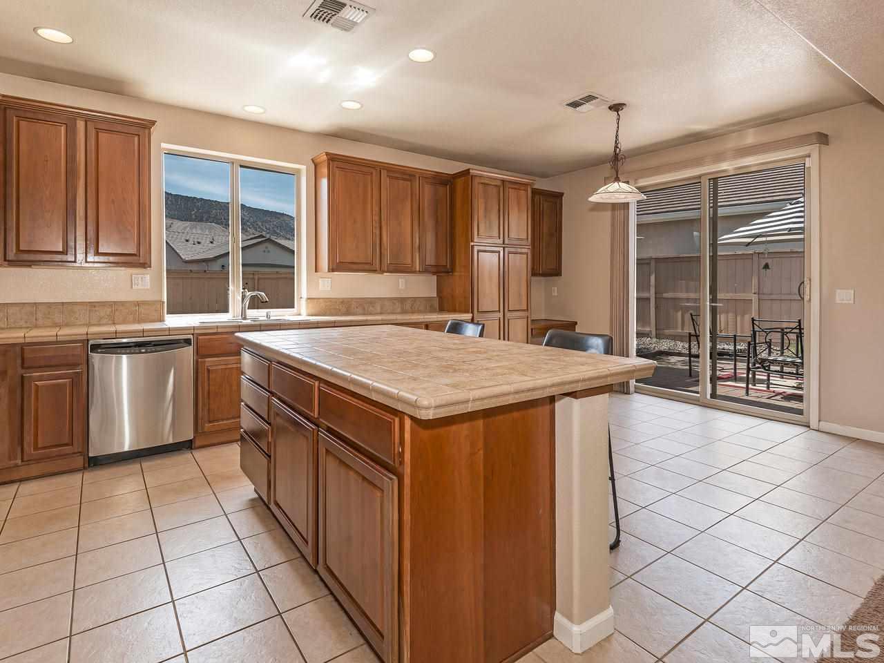 2598 Spring Flower Drive Reno, NV 89521 - Photo 8 of 21 a kitchen with a stove a sink dishwasher and a refrigerator with wooden floor