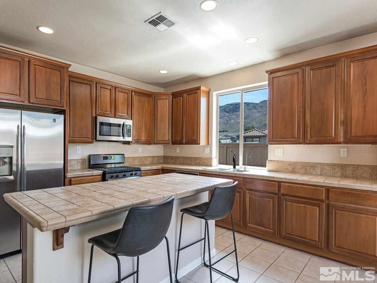 2598 Spring Flower Drive Reno, NV 89521 - Photo 9 of 21 a kitchen with granite countertop a sink appliances and cabinets
