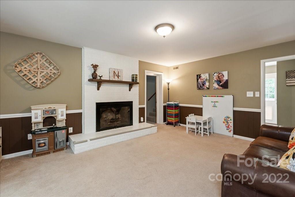 709 Neill Ridge Road Matthews, NC 28105 - Photo 13 of 38 a living room with furniture and a fireplace