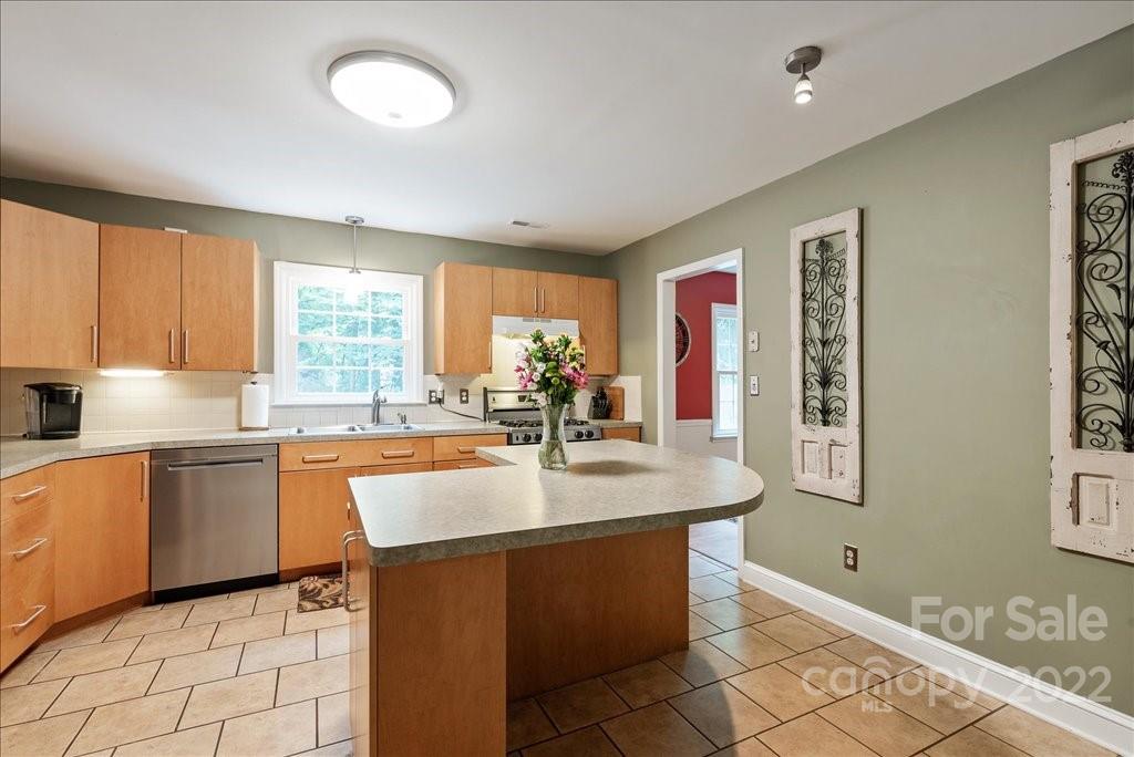 709 Neill Ridge Road Matthews, NC 28105 - Photo 15 of 38 a kitchen with stainless steel appliances granite countertop a sink and a refrigerator
