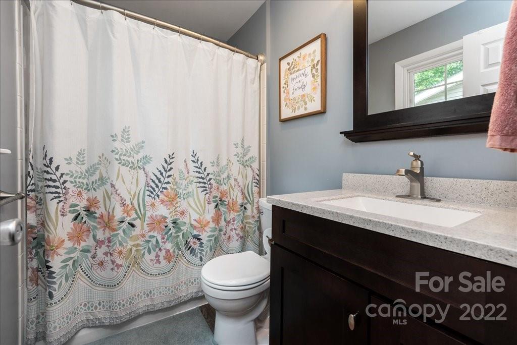 709 Neill Ridge Road Matthews, NC 28105 - Photo 21 of 38 a bathroom with a granite countertop sink and a toilet