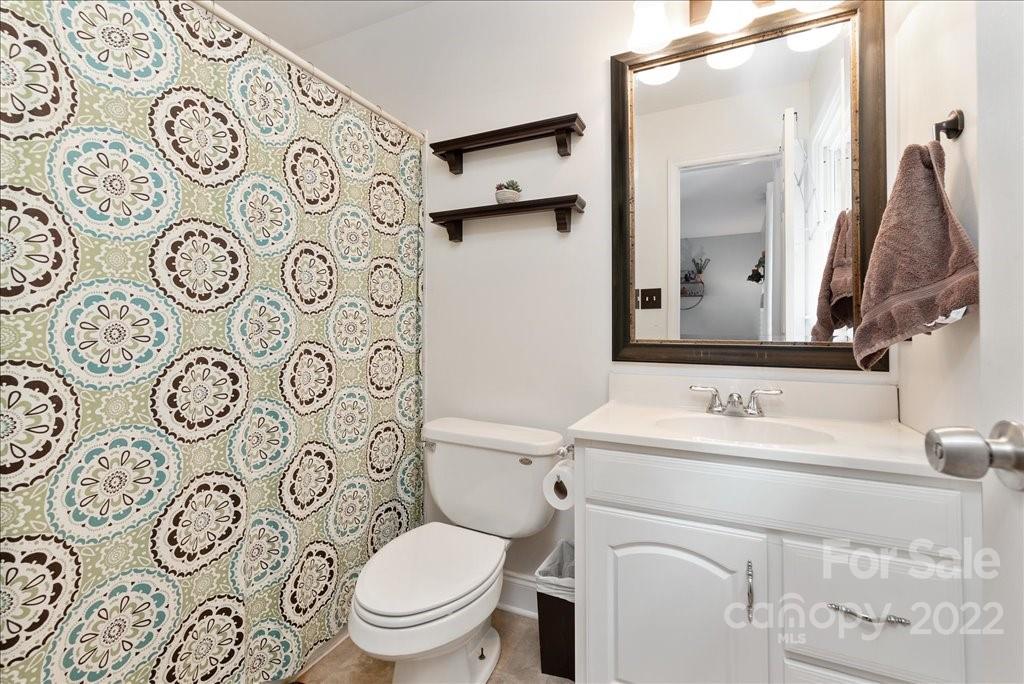 709 Neill Ridge Road Matthews, NC 28105 - Photo 24 of 38 a bathroom with a toilet sink and mirror