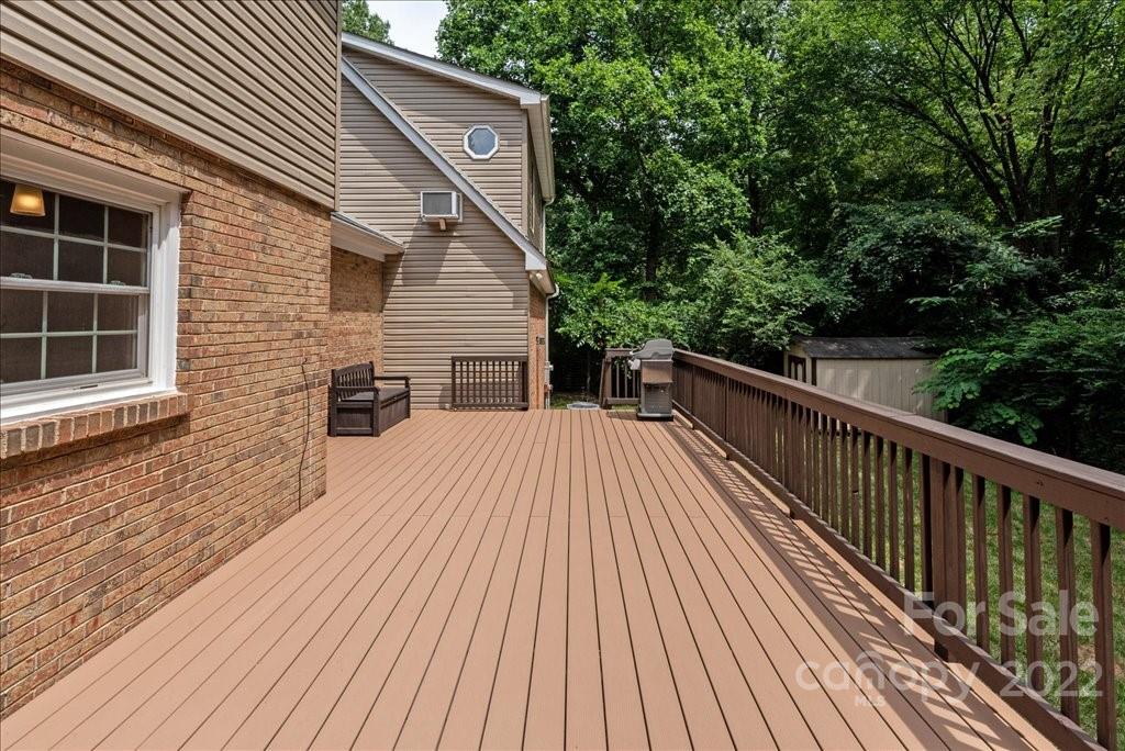 709 Neill Ridge Road Matthews, NC 28105 - Photo 29 of 38 a balcony with wooden floor and fence